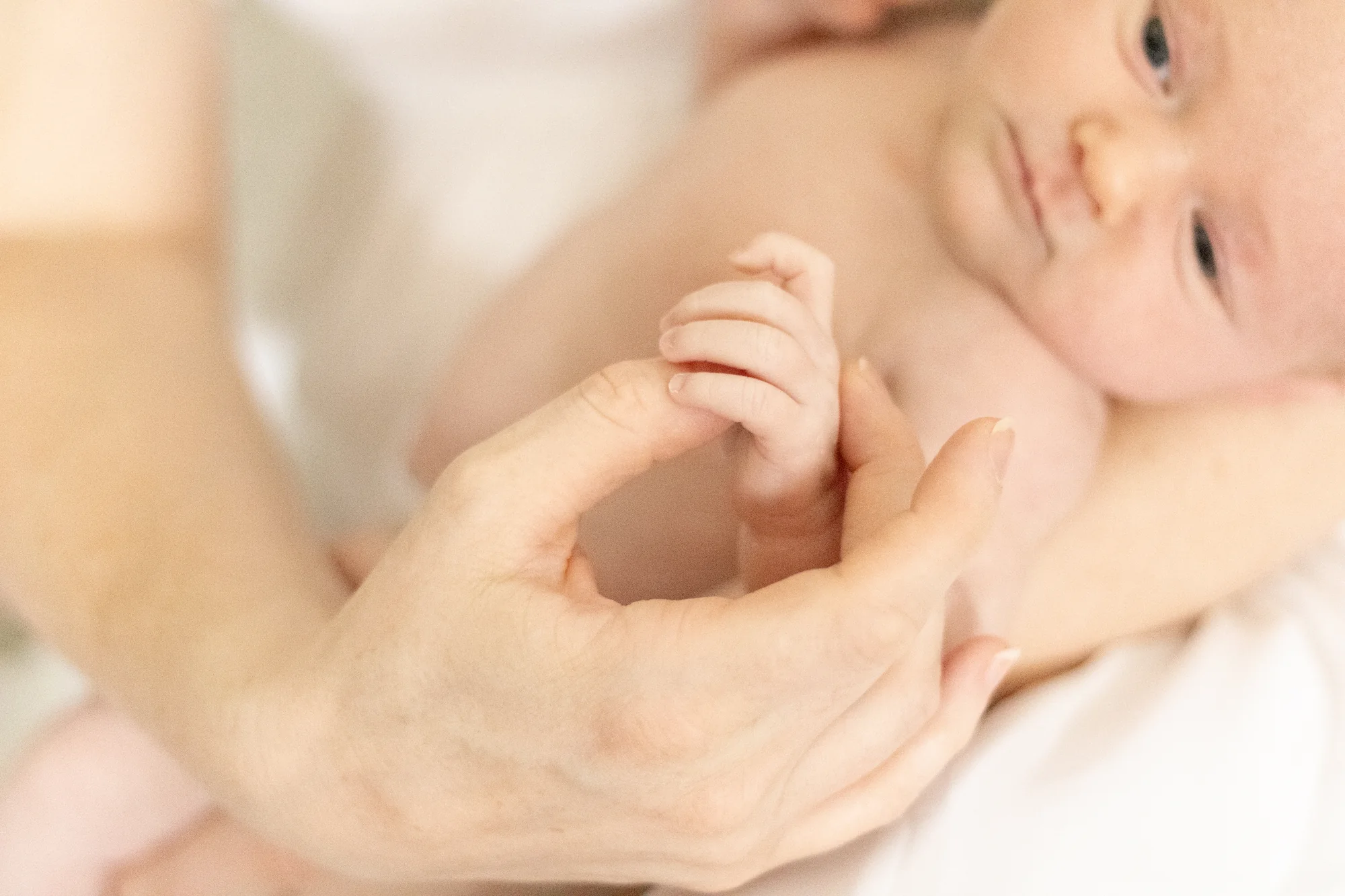 A newborn photographed in a calm home setting